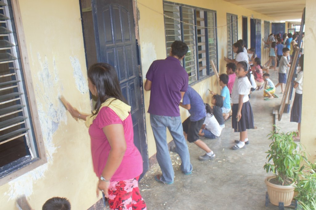 Community volunteers helping to scrape the walls