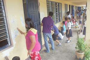 Community volunteers helping to scrape the walls