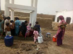 Women and children collecting clean drinking water