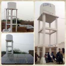 Solar panels and water tank in a town in Punjab