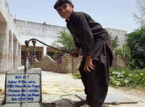 A young boy gets clean water from a new pump
