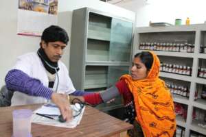 The doctor checking Mariam's blood pressure
