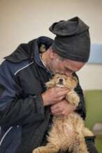 Rescuer kissing the dog he brought to us