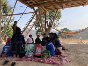 Teachers sharing about seeds with youth in village