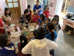 Youth from village taking baking lessons at Seeds
