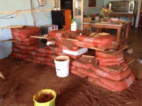 The earthen counter under construction w/ rice bag