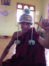 Novice monk knitting his first hat
