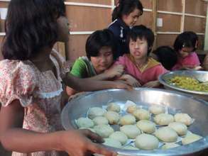 Teaching baking to children in monastery for blind