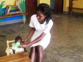 Nurse Viola feeding a severely malnourished child