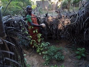 Woman Showing Pumpkin Grown in the Kitchen Garden