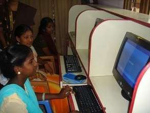 Adolescent girls learning computer skills
