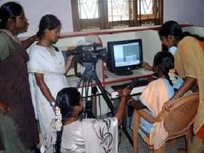 Staff members learning to use Video for empowermen
