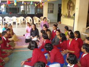 Children with volunteer enjoying studies