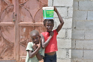 Girl getting water from purifier system