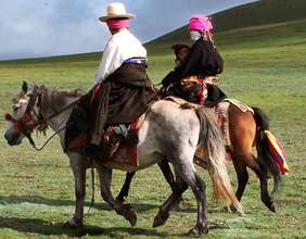 Tibetan nomad family on horseback