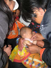 Child being vaccinated in Rima