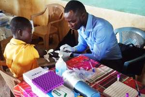 a student having blood taken for screening