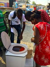 Potential customers inspect a SOIL toilet
