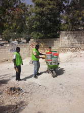 SOIL's Sasha Kramer helping collect poo buckets!