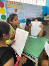 Suly reading with her classmates