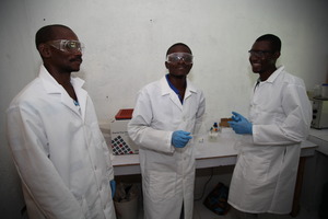 Frantz, middle, a SOIL intern in the lab