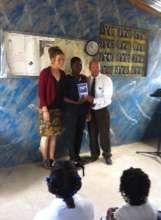 Ysaac receiving Award with Morgan and teacher