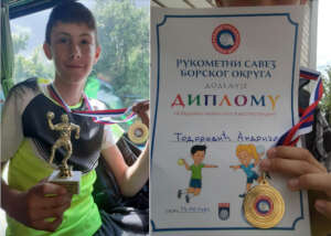 Andrija proudly holding his first medal and trophy