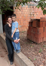 Andrija and his mother with the bricks for toilet.