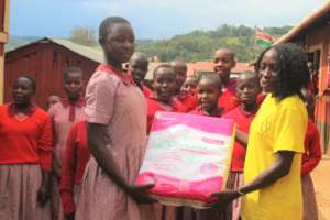Joyce,HFAW, handing over sanitary to Pisgan girls
