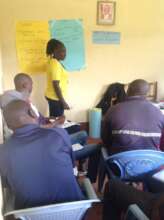 Joyce educating men on the effects of FGM