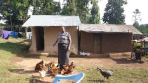 Martha smiling while feeding her chicken