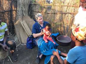 Dr. Lara examines a newborn at a homestead