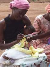 Velelaphi practising knitting in 2013