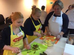 Nadya, Sveta learn to cook from a master.