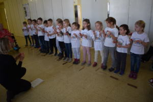 Children singing for senior patients
