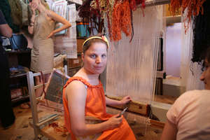 Gayane at a loom preparing handicrafts
