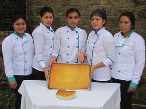 Young ladies presenting a Salvadoran pastry