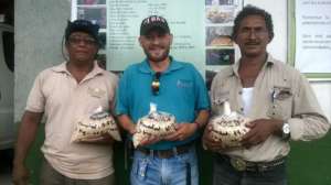 Alfredo, Rex & Isidro hold Nutrader seed to plant