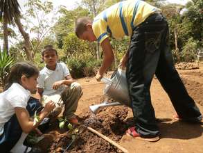 Ana's children plant a vegetable garden