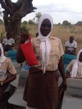 A student from Buyani with her pack of napkins