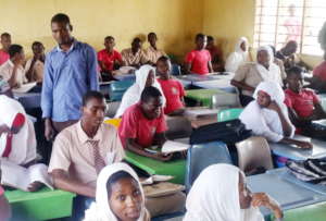 Mr Bauto in a classroom with new desks