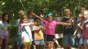 Alyssa, yellow T-shirt, in the Forest Edge Camp