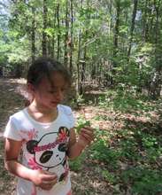 Caroline eating grape leaves