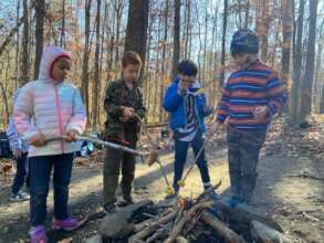 Roasting Lunches Over a Fire