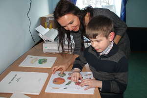 A blind boy is studying the tactile image