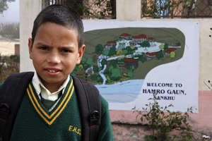 Standing outside his first school