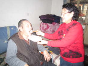 the senior was feeding the older senior dumplings