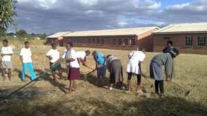 Maranatha students&beneficiaries clearing the land