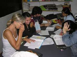 Trainees studying with volunteers that help them w