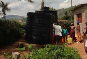 Collecting water at Trust Each Other's water point